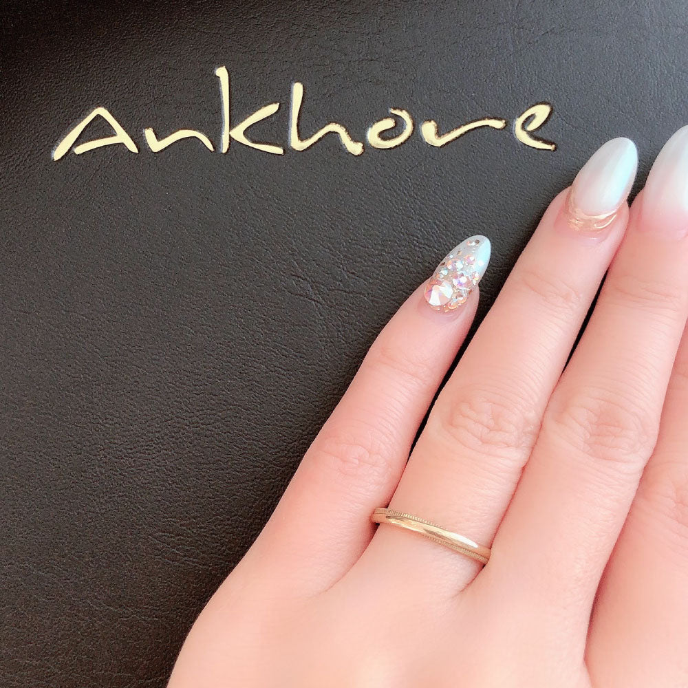 Wedding band （wedding ring）worn on hand in posed still image for styling display