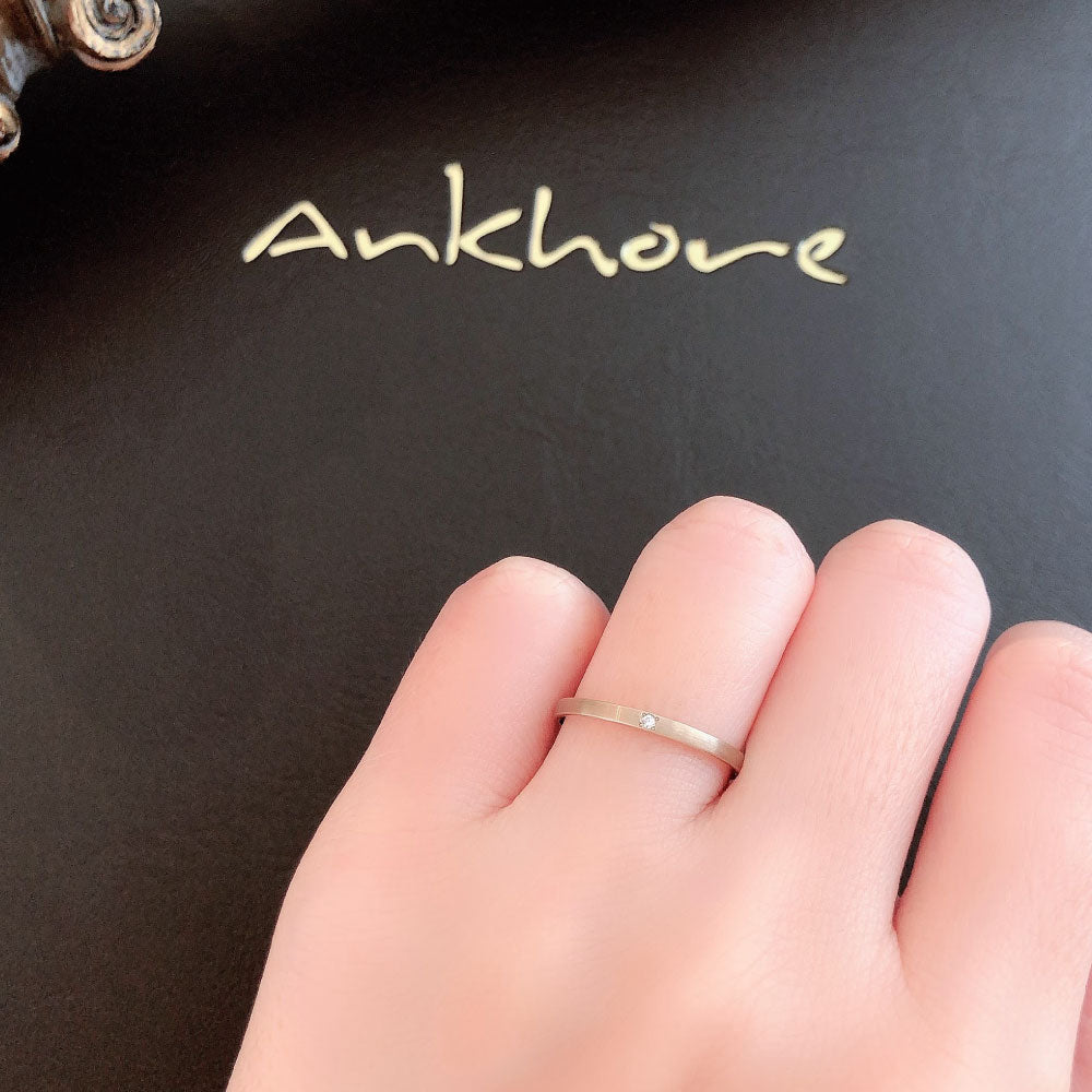 Wedding band （wedding ring）worn on hand in posed still image for styling display