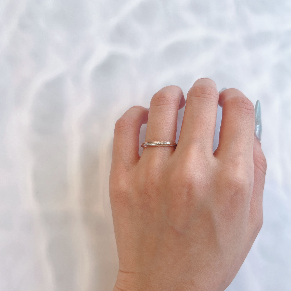 Wedding band （wedding ring）worn on hand in posed still image for styling display