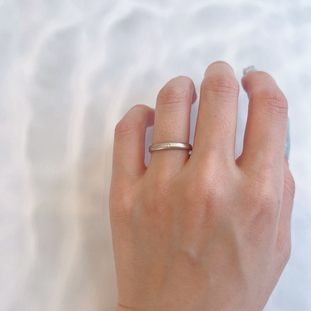 Wedding band （wedding ring）worn on hand in posed still image for styling display
