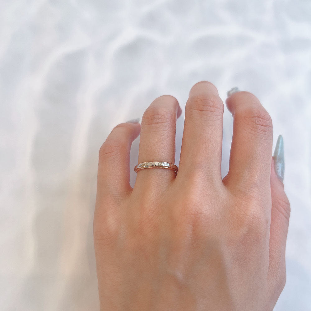 Wedding band （wedding ring）worn on hand in posed still image for styling display