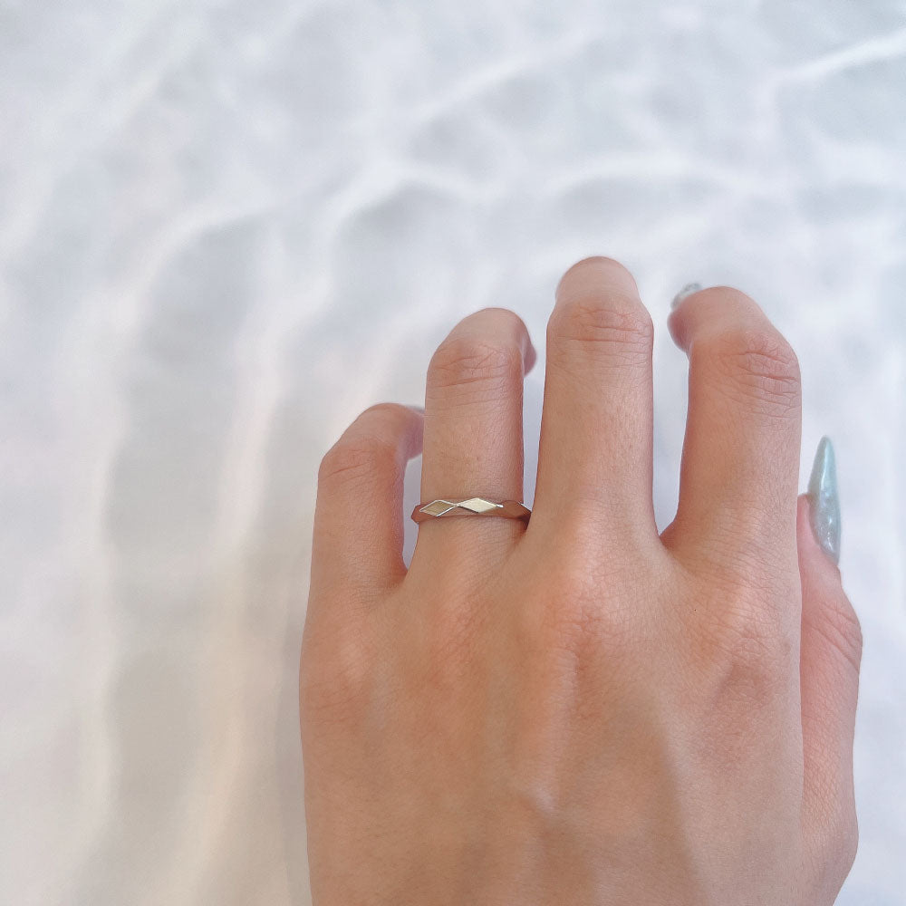 Wedding band （wedding ring）worn on hand in posed still image for styling display