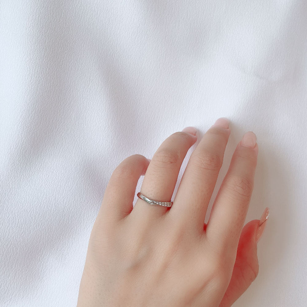 Wedding band （wedding ring）worn on hand in posed still image for styling display