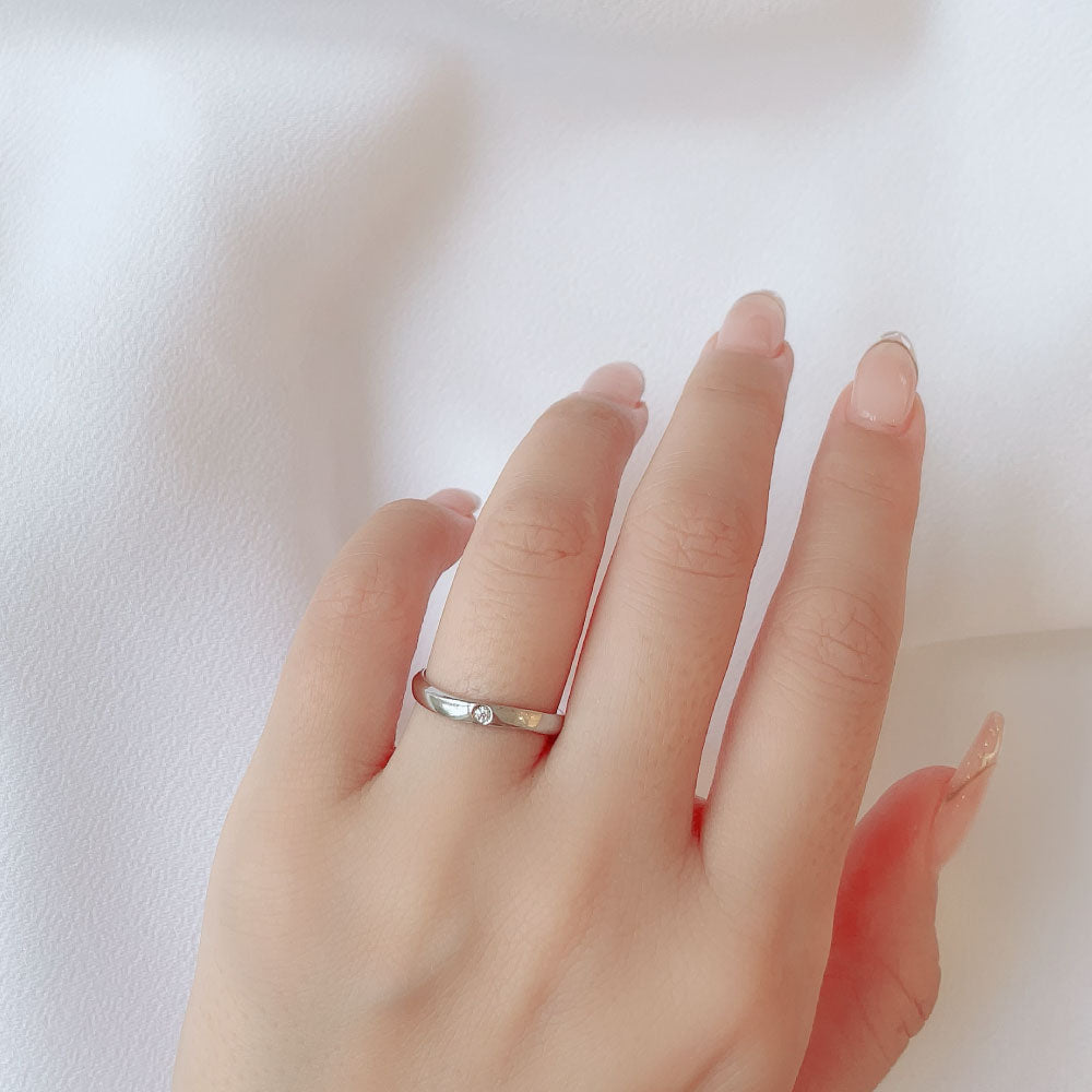 Wedding band （wedding ring）worn on hand in posed still image for styling display
