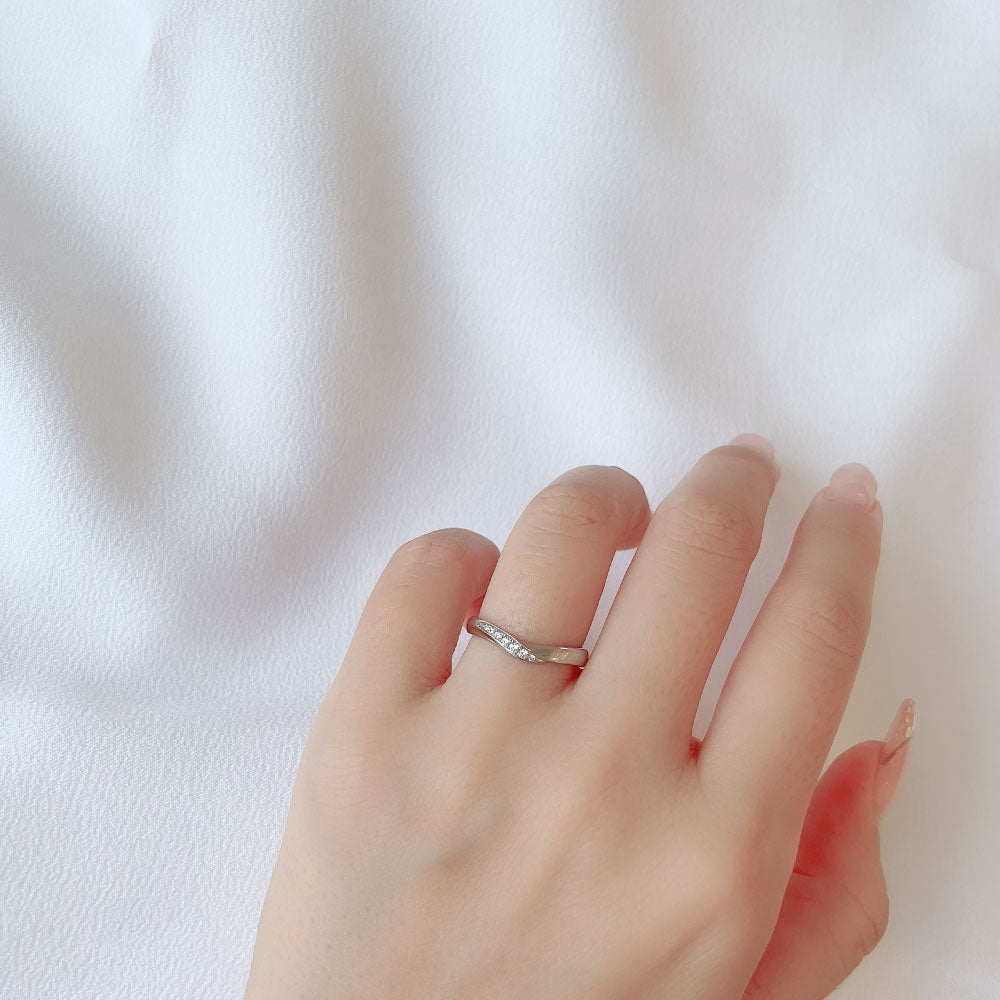 Wedding band （wedding ring）worn on hand in posed still image for styling display