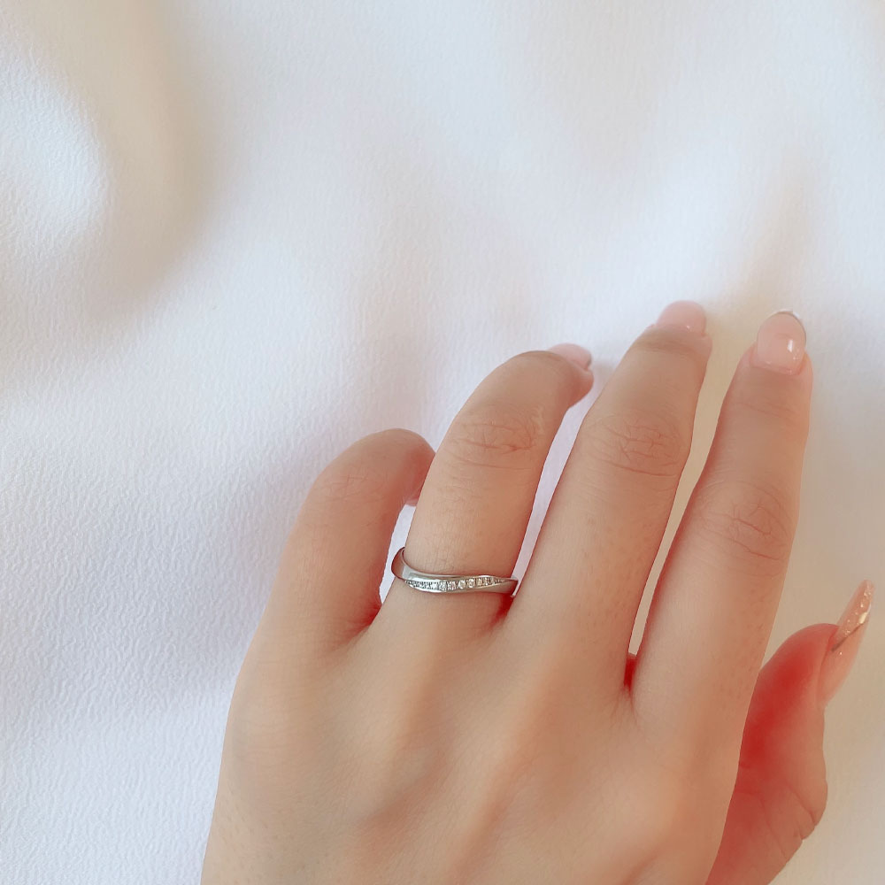 Wedding band （wedding ring）worn on hand in posed still image for styling display