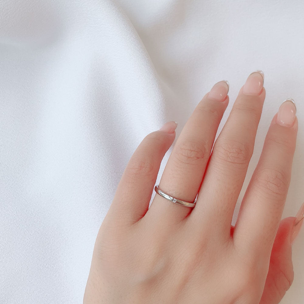 Wedding band （wedding ring）worn on hand in posed still image for styling display