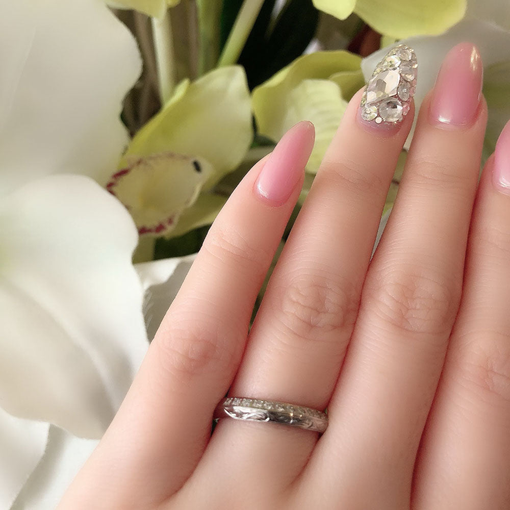 Wedding band （wedding ring）worn on hand in posed still image for styling display